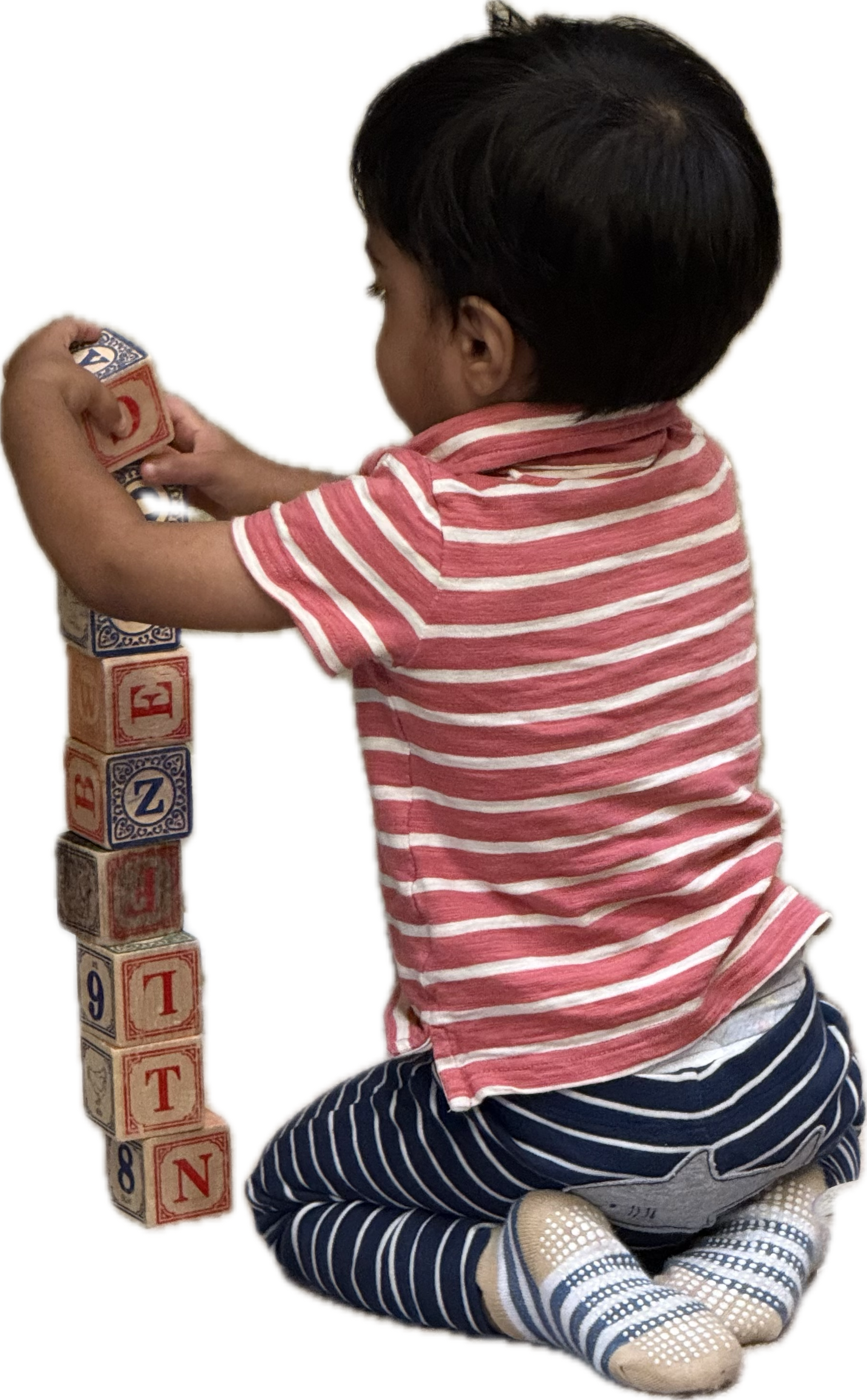 A child stacking alphabet blocks